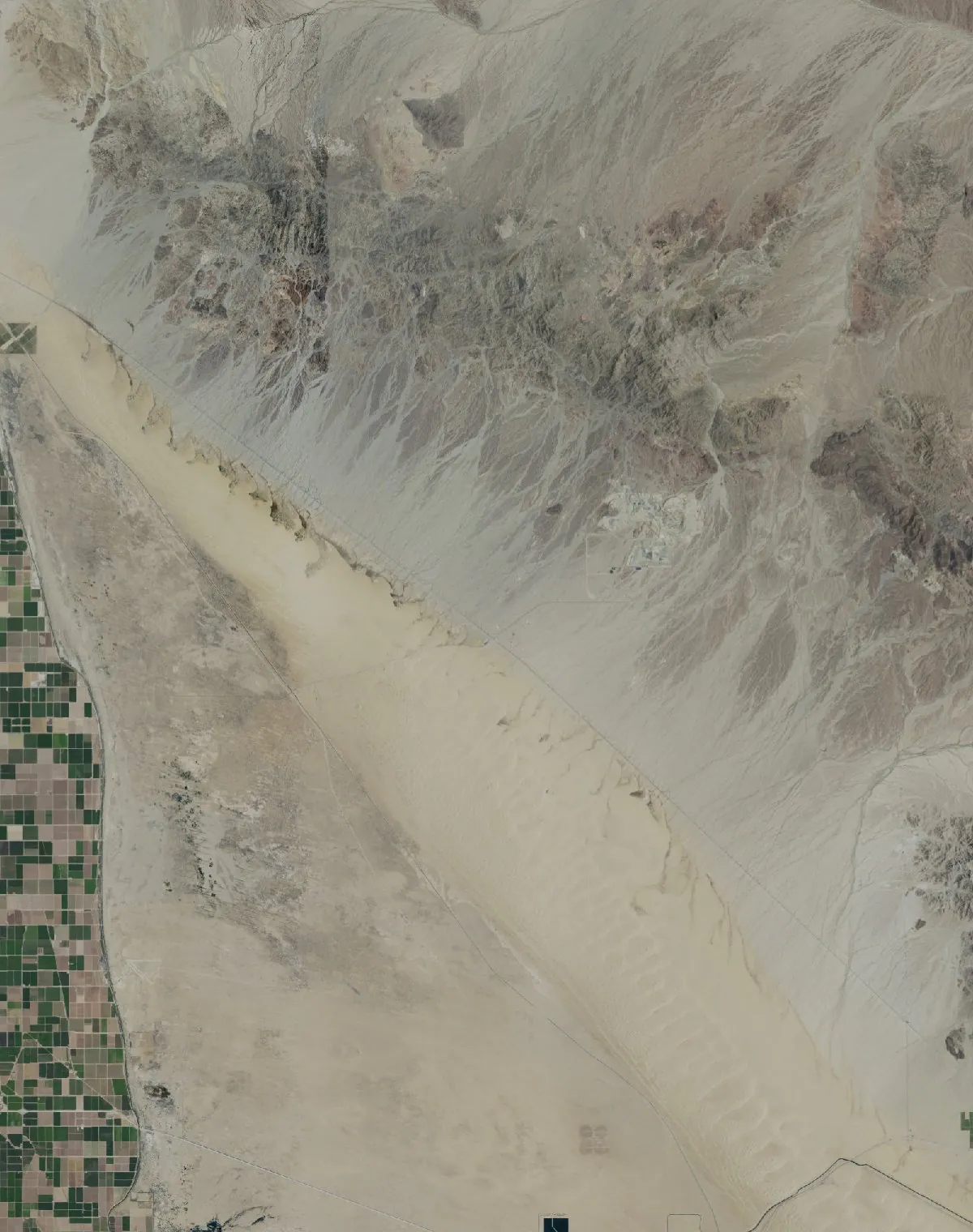 The whole dune field as flat NAIP imagery: one long stretch of beige sand